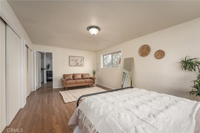 bedroom with a closet and dark hardwood / wood-style flooring