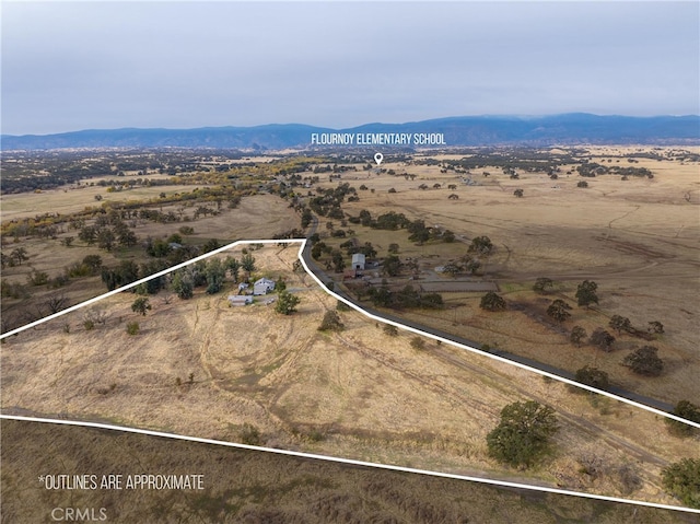 drone / aerial view featuring a mountain view and a rural view