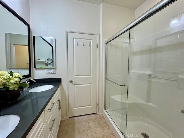 bathroom with vanity and a shower with door