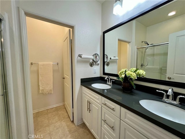 bathroom featuring vanity, tile patterned flooring, and walk in shower