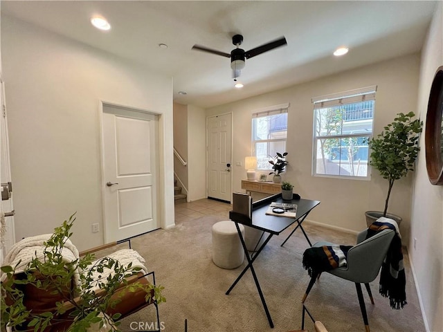 carpeted home office with ceiling fan