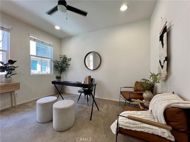 carpeted office space with ceiling fan