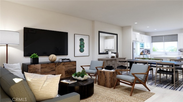 living area with light wood-type flooring and recessed lighting