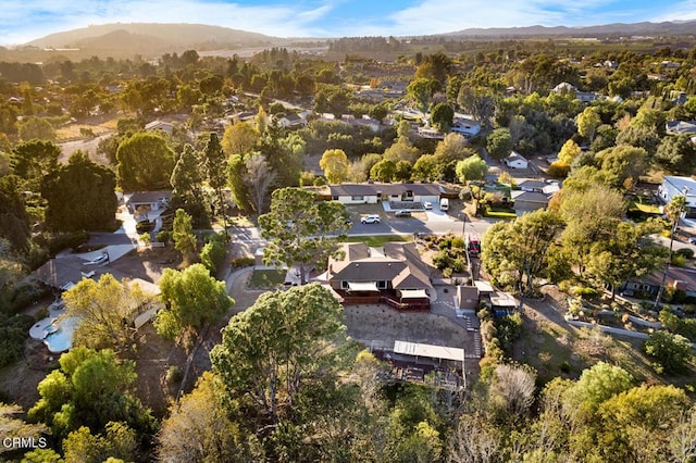 drone / aerial view featuring a residential view and a mountain view