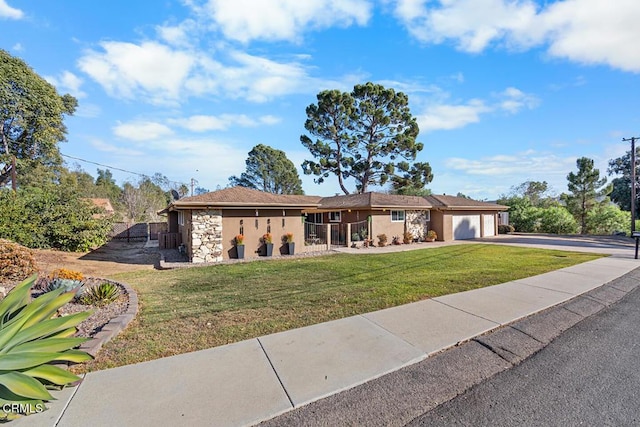 single story home with a garage, fence, and a front lawn