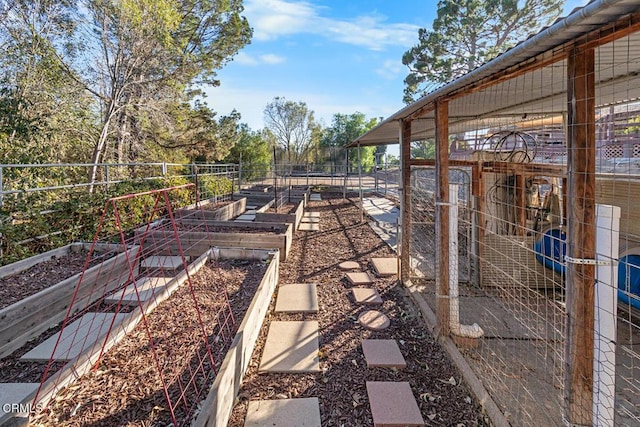 view of yard with a garden and an outbuilding