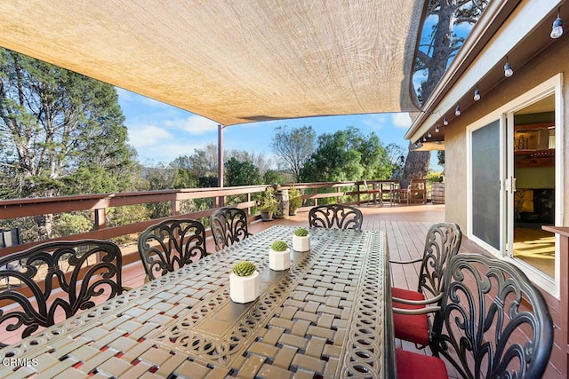 view of patio with outdoor dining area and a deck