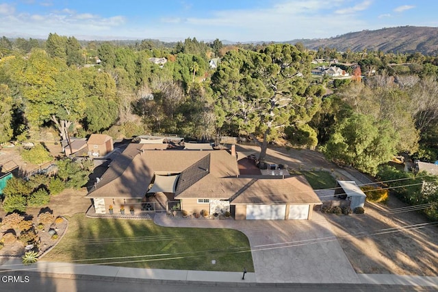 aerial view featuring a mountain view and a wooded view