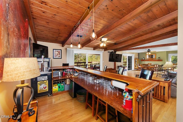 interior space featuring a wealth of natural light, beam ceiling, and hardwood / wood-style floors