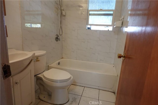 full bathroom featuring toilet, vanity, tiled shower / bath, and tile patterned flooring