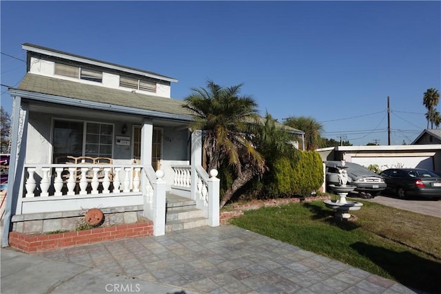 view of front of home featuring an outdoor structure and covered porch