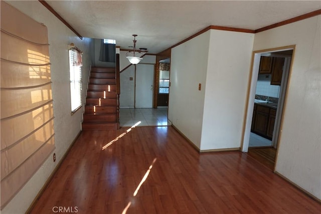 interior space with wood-type flooring and crown molding