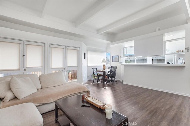 living area with beamed ceiling, baseboards, and dark wood-style flooring