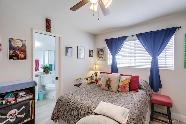 bedroom with connected bathroom, ceiling fan, and light hardwood / wood-style floors