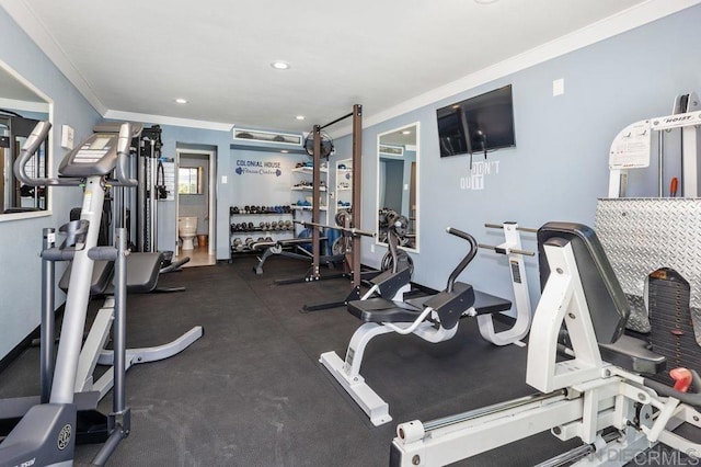 workout area featuring crown molding