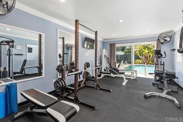 workout area featuring crown molding