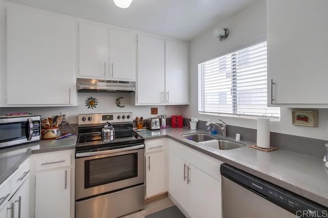 kitchen with white cabinets, stainless steel appliances, and sink