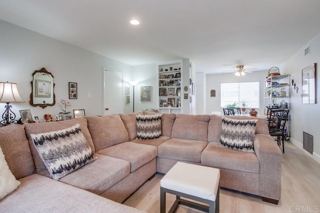 living room featuring ceiling fan and light wood-type flooring