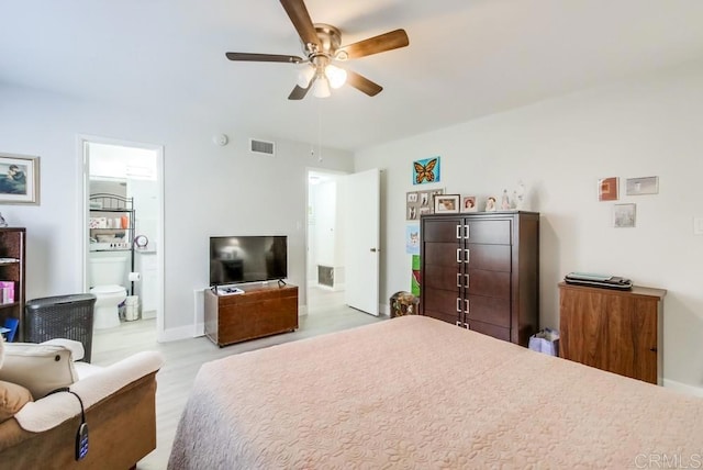 bedroom with ensuite bathroom, ceiling fan, and light hardwood / wood-style floors