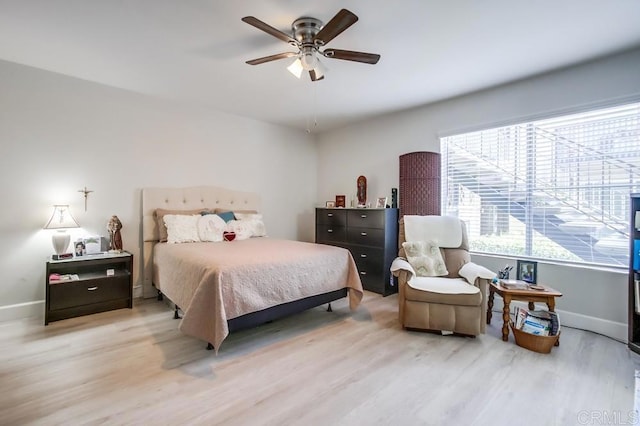 bedroom with light hardwood / wood-style floors and ceiling fan