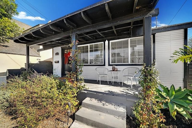 view of exterior entry featuring a porch