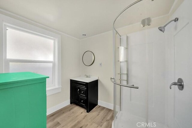 bathroom featuring wood-type flooring, vanity, and walk in shower