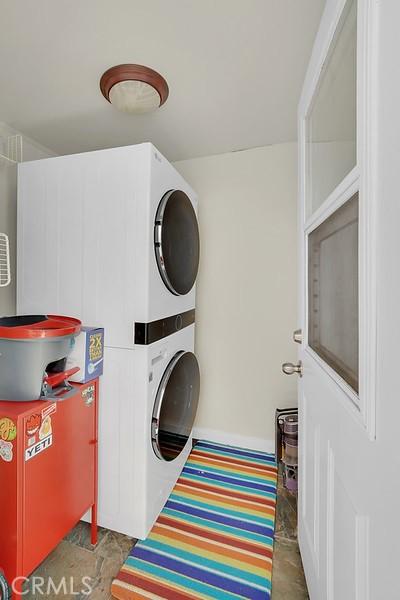 washroom with stacked washer / dryer