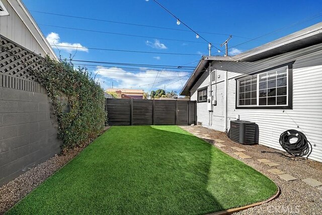 view of yard featuring central AC unit