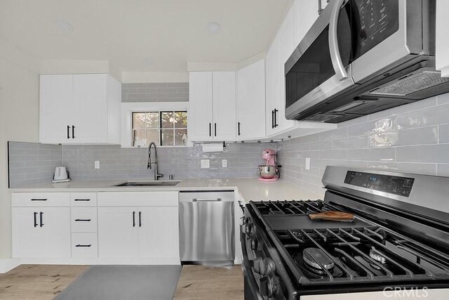 kitchen featuring white cabinets, sink, and appliances with stainless steel finishes