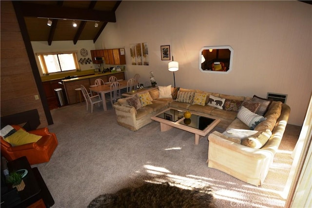 carpeted living room featuring beamed ceiling and high vaulted ceiling