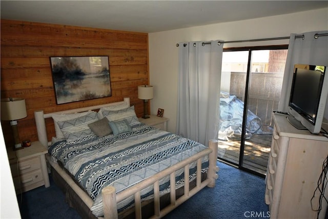 carpeted bedroom with wood walls