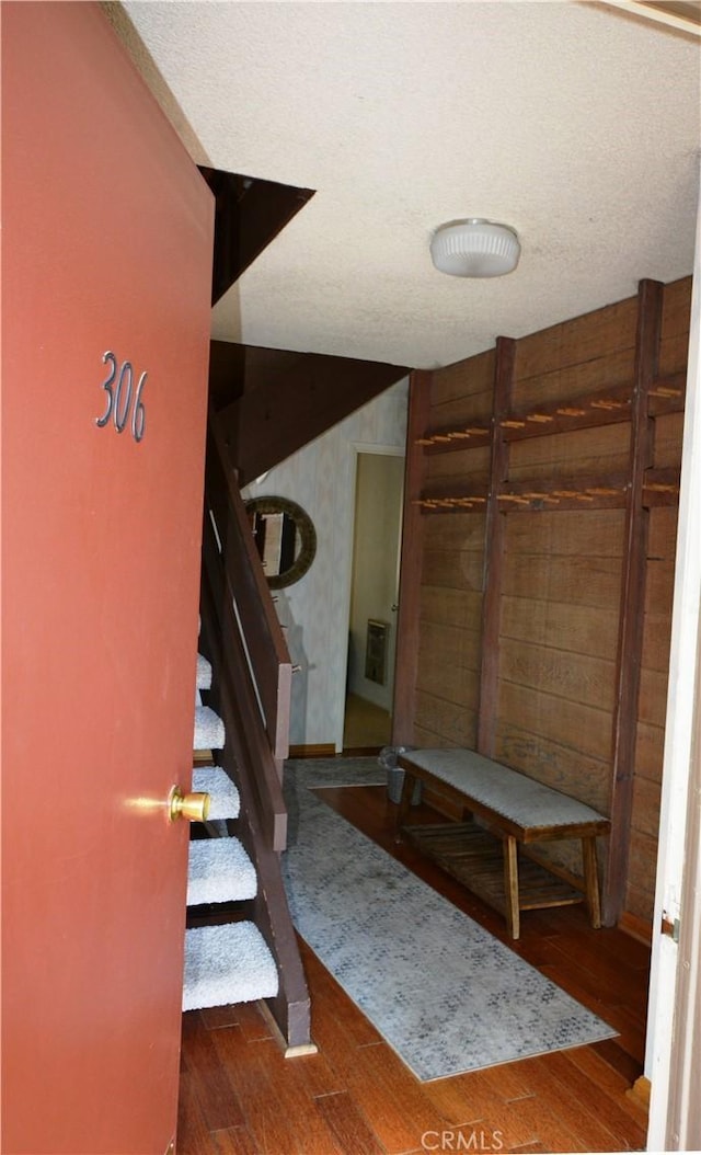 foyer with a textured ceiling and dark hardwood / wood-style floors