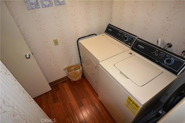 clothes washing area featuring independent washer and dryer and dark wood-type flooring