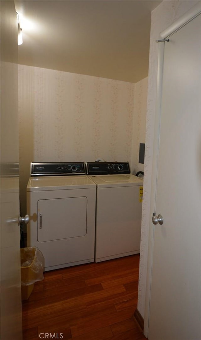 laundry area featuring washer and dryer and dark hardwood / wood-style flooring