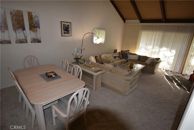 dining space with vaulted ceiling with beams, carpet floors, and wood ceiling