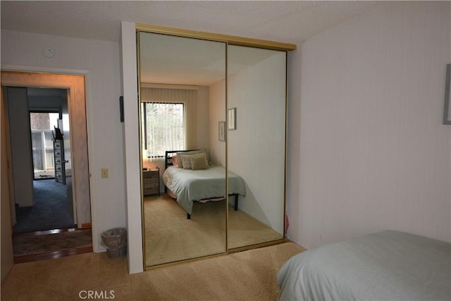 carpeted bedroom with multiple windows and a closet