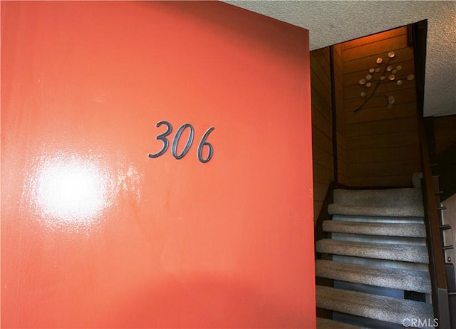 staircase with a textured ceiling