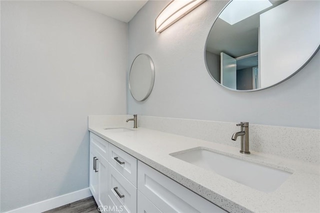 bathroom with vanity and hardwood / wood-style flooring