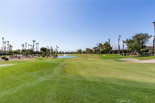 view of property's community featuring a yard and a water view