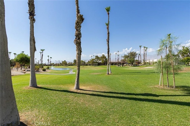 view of home's community featuring a lawn and a water view