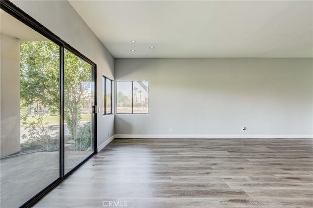 unfurnished room with light wood-type flooring