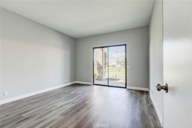 unfurnished room with hardwood / wood-style flooring