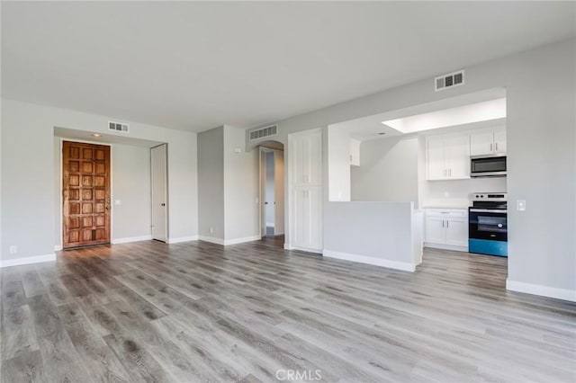 unfurnished living room with light hardwood / wood-style floors