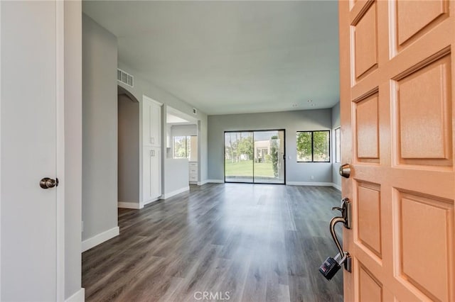 empty room with dark hardwood / wood-style flooring