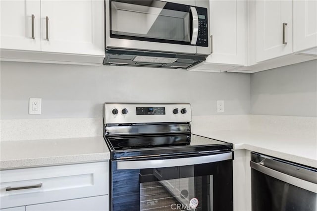 kitchen with white cabinetry and appliances with stainless steel finishes