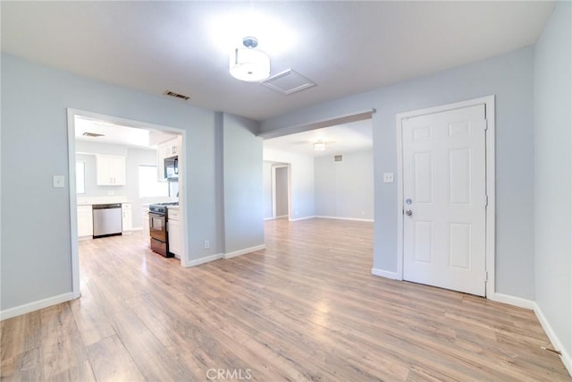 spare room featuring light hardwood / wood-style floors