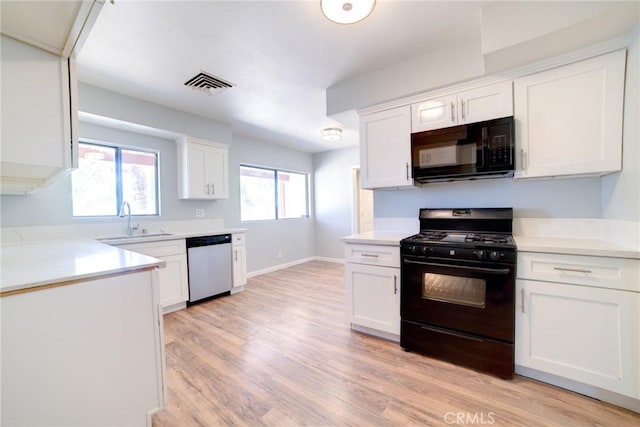 kitchen featuring light hardwood / wood-style flooring, white cabinets, black appliances, and sink