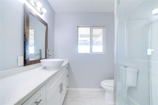 bathroom featuring vanity, toilet, and an enclosed shower