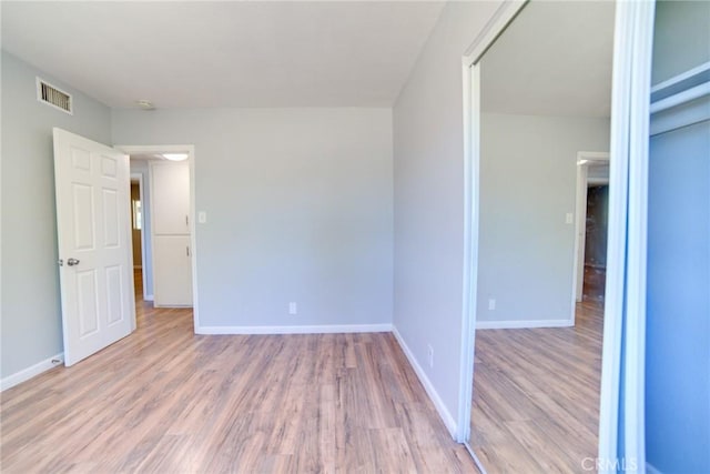 spare room featuring light hardwood / wood-style floors