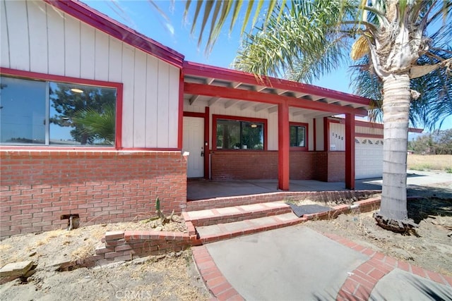 view of exterior entry with a garage